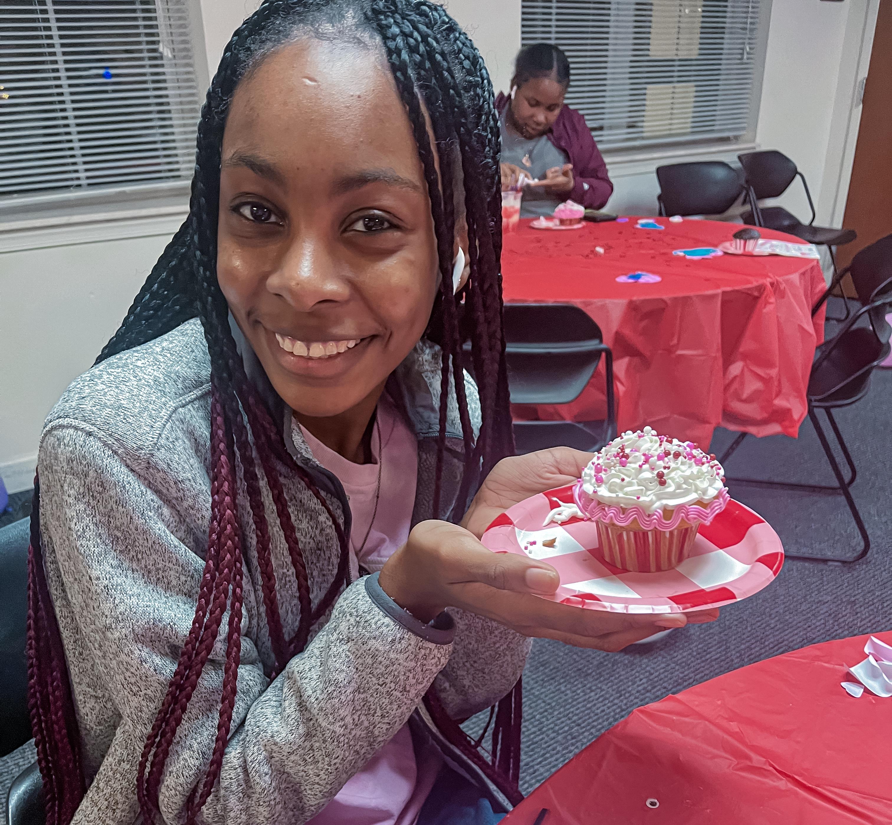 Resident - Student Holding Cupcake from RM Program